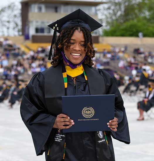 Graduate student walking at graduation