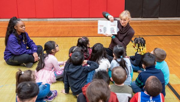 Children in a circle listening to reader