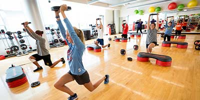 group fitness class lifting weights