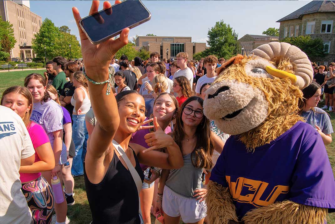 Students taking selfie with Rammy