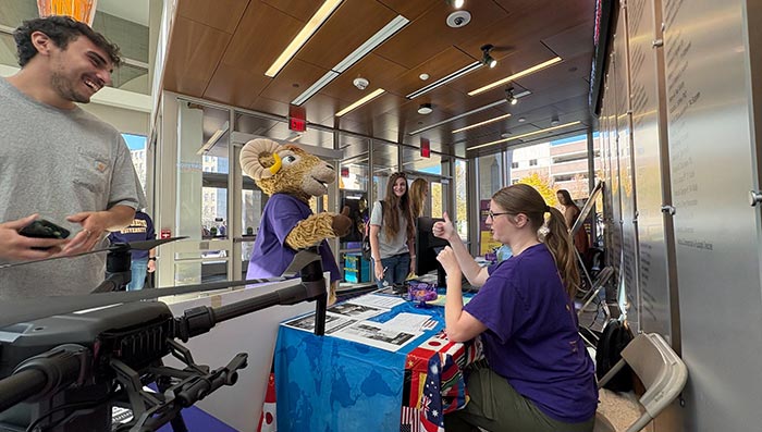 STudent worker at outreach table