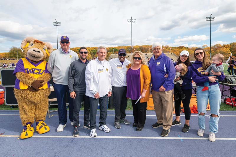 Pictured with Rammy at Homecoming, during which the football field was named, are (L-R) Terry Beattie, WCU director of athletics; Thomas W. Fillippo ’15, president and CEO of Devault Foods (Tom's son); Tom Fillippo ’69, honoree; Dr. Zeb Davenport, vice president for university advancement and external affairs; Dr. Laurie Bernotsky, WCU president; Robert “Tommy” Tomlinson ’70, honoree; Kathleen “K.C.” Tomlinson, PA state representative (Tommy's daughter) with Landry; and Maddie Tomlinson (Tommy's other daughter) with Connell.