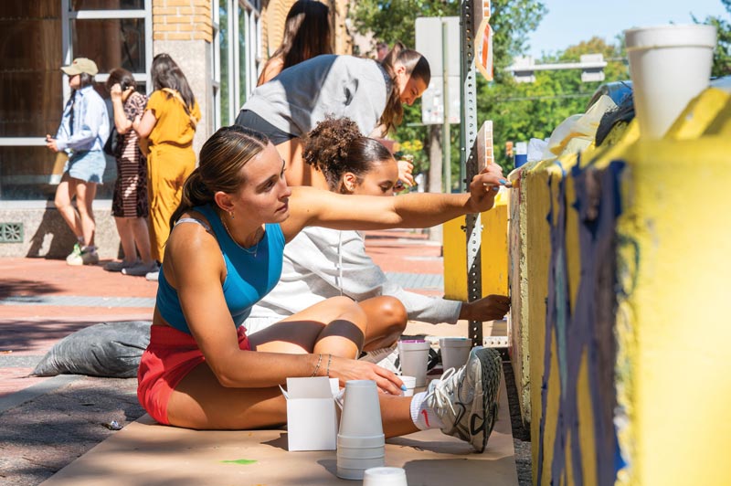 WCU students engage in beautification projects in the borough such as painting road barriers for the closure of Gay Street, conducting clean-ups, and hanging holiday greens.