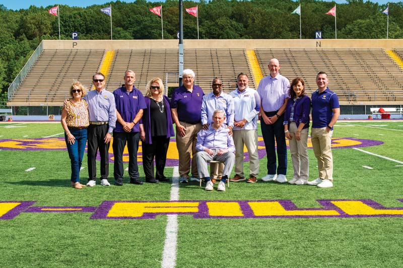 PICTURED (L TO R) on Tomlinson-Fillippo Field are Agnes Ware, Roger Ware ’82, Head Football Coach Duke Greco, West Chester University President Dr. Laurie Bernotsky, Robert “Tommy” Tomlinson ’70, Tom Fillippo ’69 (sitting), Vice President for University Advancement and External Affairs Dr. Zebulun Davenport, Vice President of University Affairs and Chief of Staff Andrew Lehman, Director of Athletics Terry Beattie, Executive Director of the West Chester University Foundation Deb Cornelius, and President of Commonwealth University Dr. Jeffery Osgood, Jr.