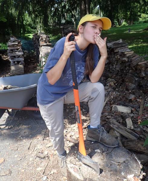 Jess enjoying a candy cigarette after a hard morning at the biochar kiln