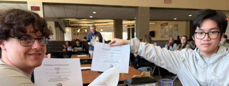 Students holding up award certificates