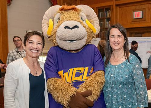 Dr. Michelle Blake and Dr. Shannon Mrkich posing with Rammy at the Faculty Mentoring 15th Anniversary Celebration in May 2024. 